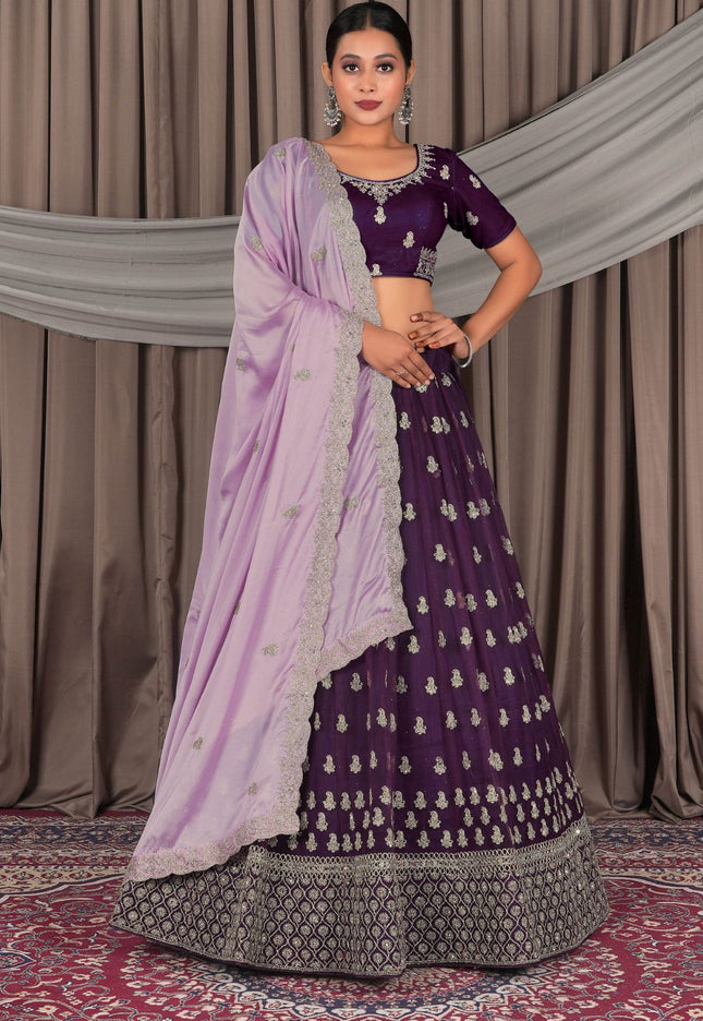 Woman wearing a traditional purple and lavender lehenga with a matching blouse