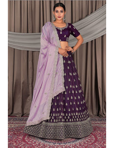 Woman wearing a traditional purple and lavender lehenga with a matching blouse