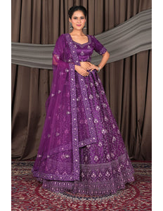 Woman wearing a purple embroidered traditional lehenga choli