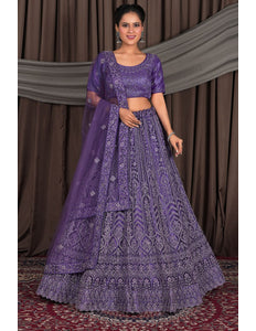 Woman wearing a purple embroidered traditional outfit against