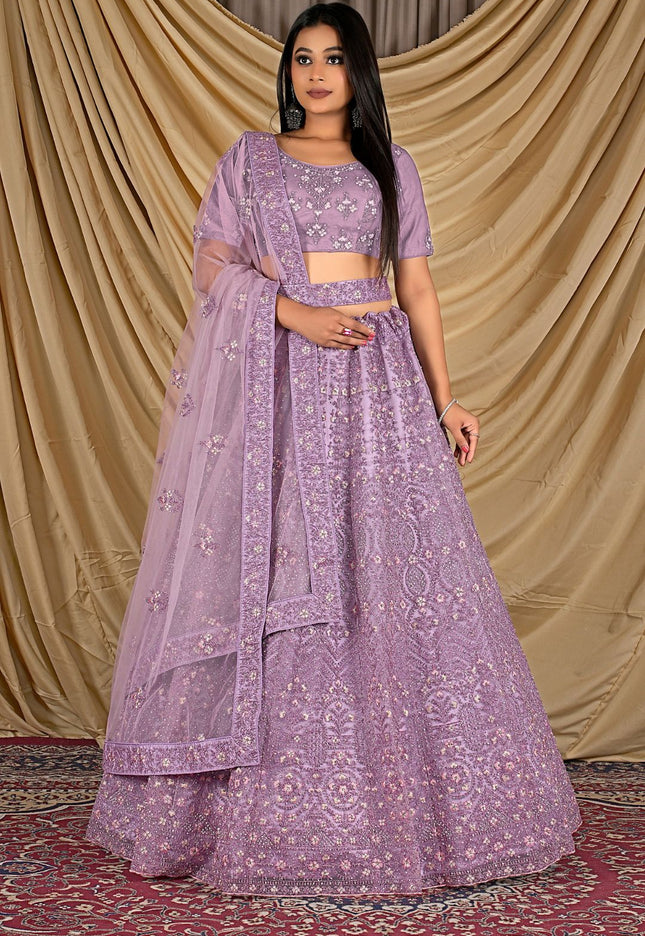 Woman wearing a purple traditional outfit with dupatta