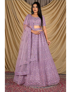 Woman wearing a purple traditional outfit with dupatta