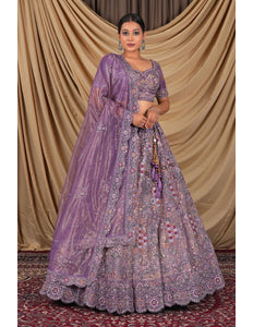 Woman wearing a purple embroidered traditional outfit