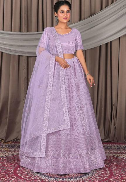 Woman wearing a lavender traditional outfit with a matching dupatta