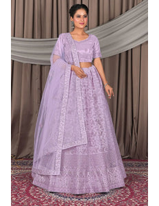 Woman wearing a lavender traditional outfit with a matching dupatta