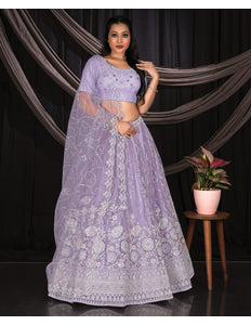 Woman in a Purple embroidered traditional lehenga choli outfit