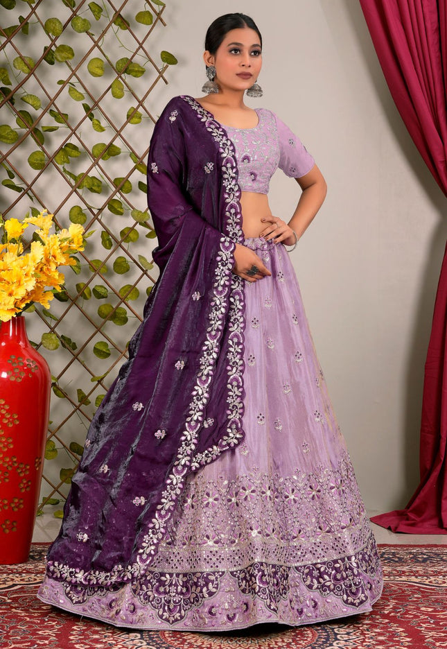 Woman wearing a traditional purple and lavender lehenga choli