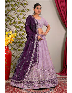 Woman wearing a traditional purple and lavender lehenga choli