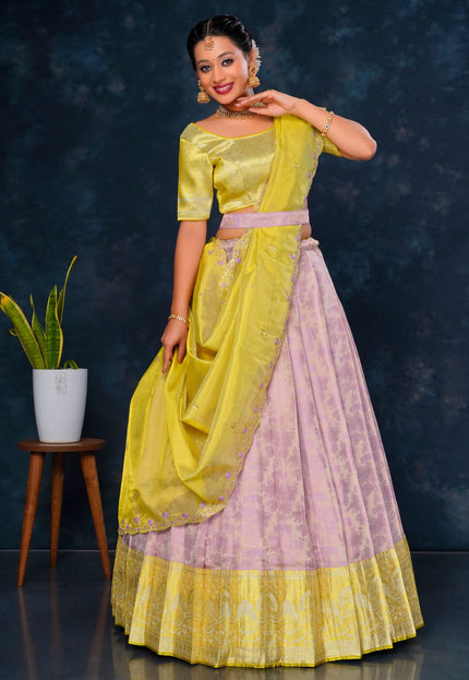 Woman wearing a yellow and pink traditional lehenga choli with dupatta