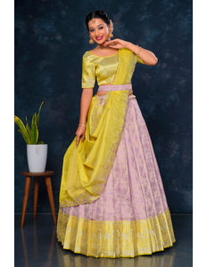 Woman wearing a yellow and pink traditional lehenga choli with dupatta