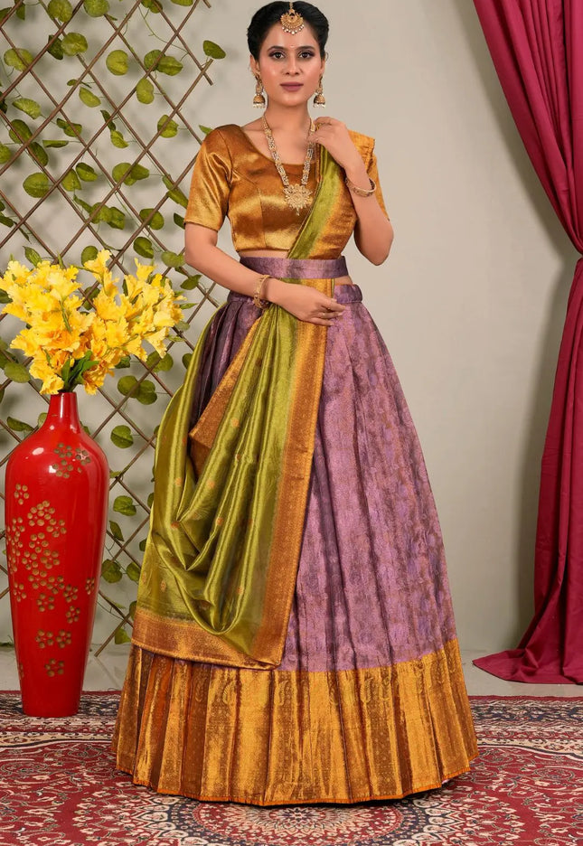 Woman wearing a traditional outfit with a green and purple lehenga choli with dupatta