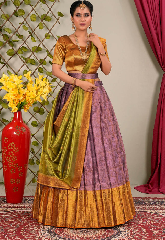 Woman wearing a traditional outfit with a green and purple lehenga choli with dupatta