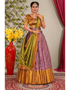 Woman wearing a traditional outfit with a green and purple lehenga choli with dupatta