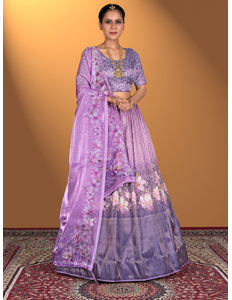 Woman wearing a purple lehenga choli with floral patterns