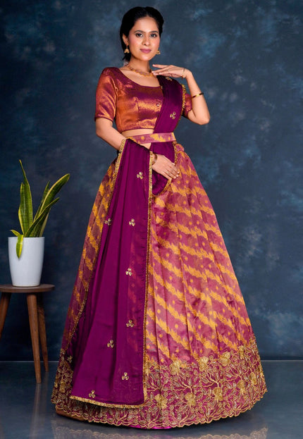 Woman wearing a traditional purple lehenga choli with dupatta