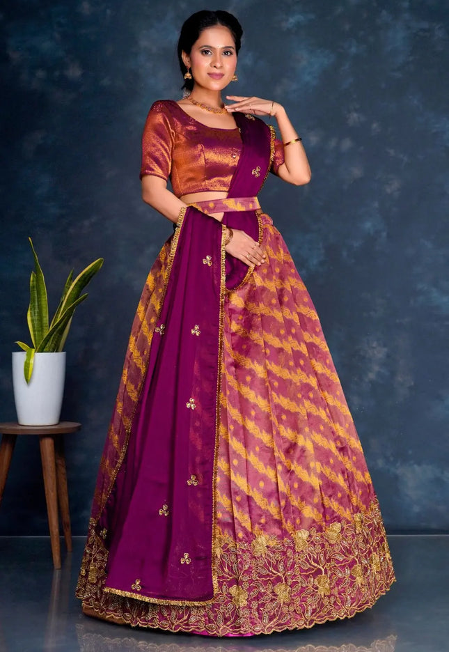 Woman wearing a traditional purple lehenga choli with dupatta