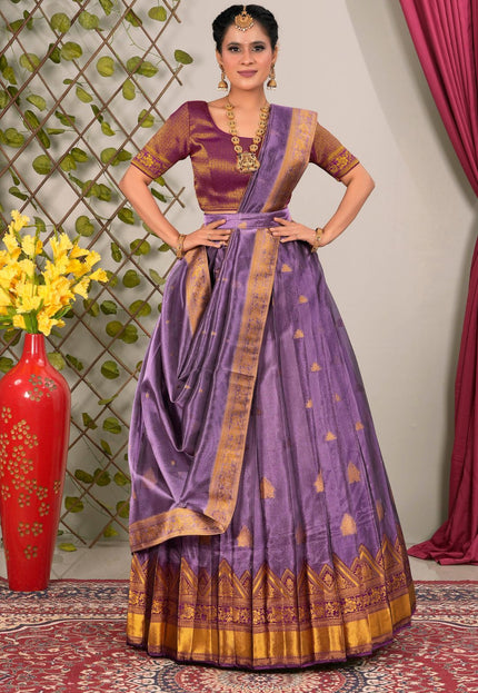 Woman wearing a traditional purple lehenga choli with dupatta