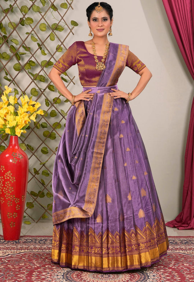 Woman wearing a traditional purple lehenga choli with dupatta