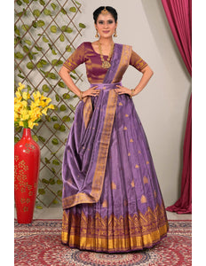 Woman wearing a traditional purple lehenga choli with dupatta