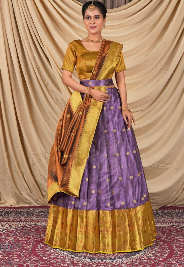 Woman wearing a traditional outfit with a gold blouse and purple skirt