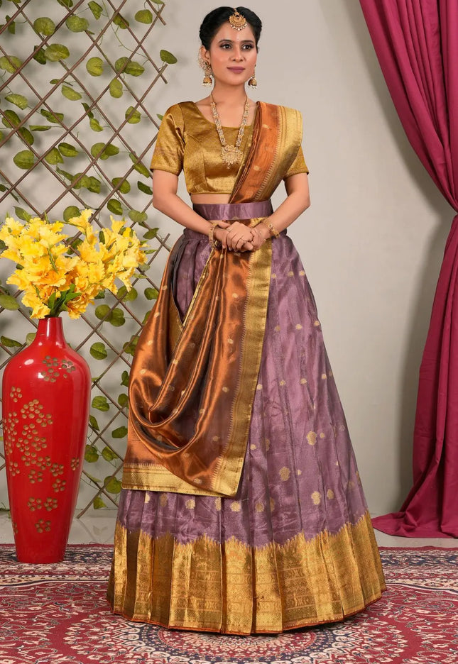 Woman in traditional outfit with gold and purple lehenga choli with dupatta