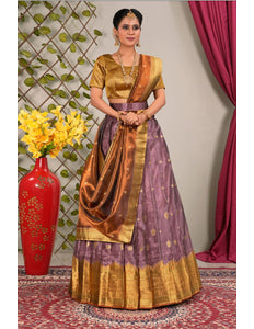 Woman in traditional outfit with gold and purple lehenga choli with dupatta