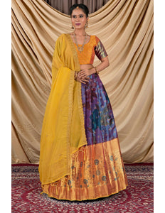 Woman wearing a traditional outfit with a yellow blouse and colorful skirt