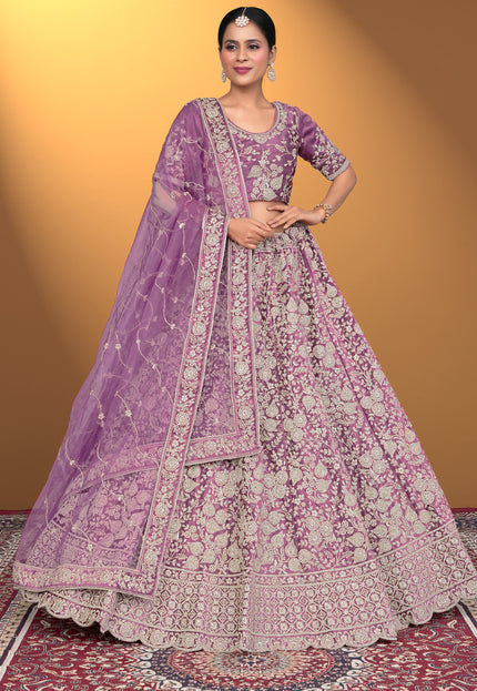 Woman wearing a traditional purple and pink embroidered outfit