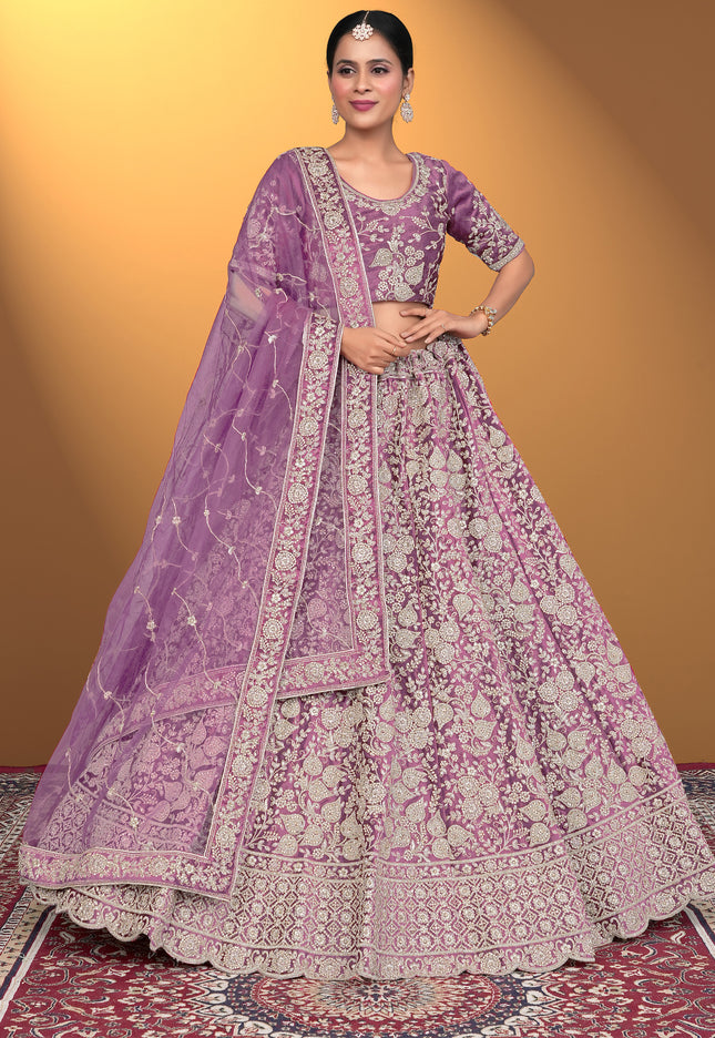 Woman wearing a traditional purple and pink embroidered outfit
