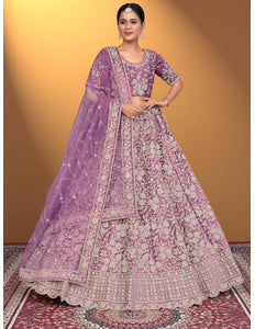 Woman wearing a traditional purple and pink embroidered outfit