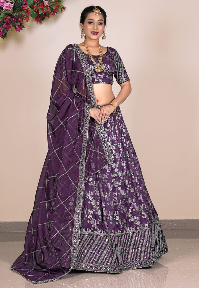 Woman wearing a purple traditional outfit with a matching dupatta