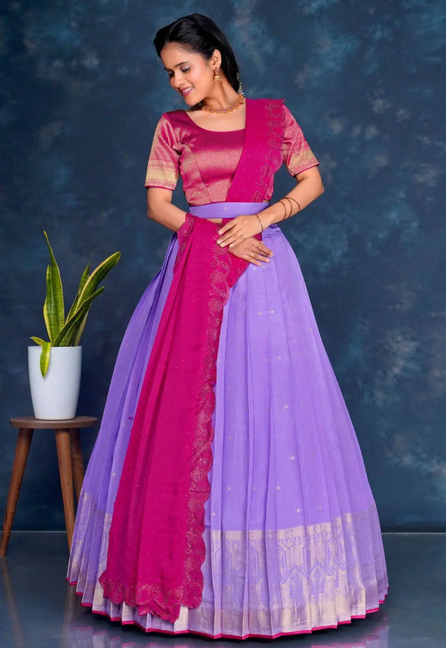 Woman wearing a pink and purple traditional lehenga choli with dupatta
