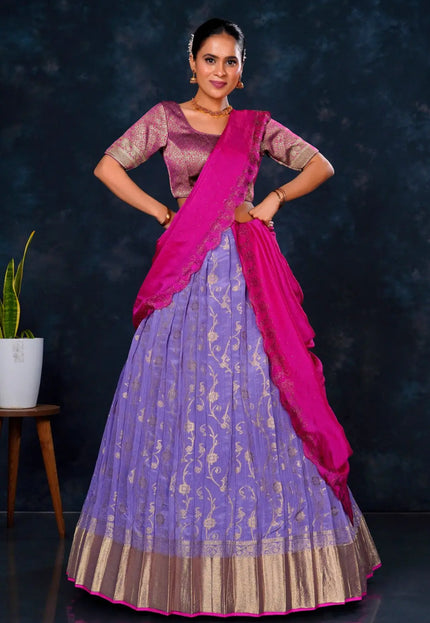 Woman in a traditional outfit with a purple lehenga and pink blouse