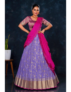 Woman in a traditional outfit with a purple lehenga and pink blouse