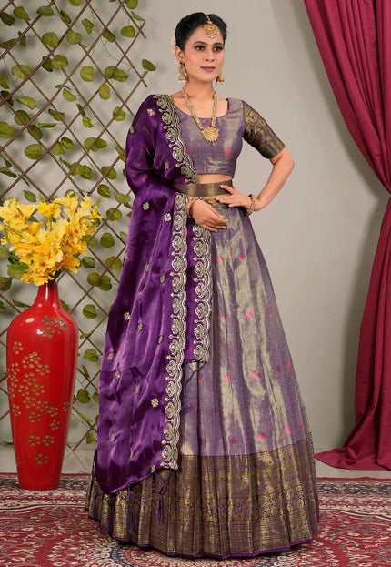 Woman in a traditional purple and gray lehenga choli with dupatta