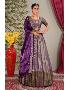 Woman in a traditional purple and gray lehenga choli with dupatta