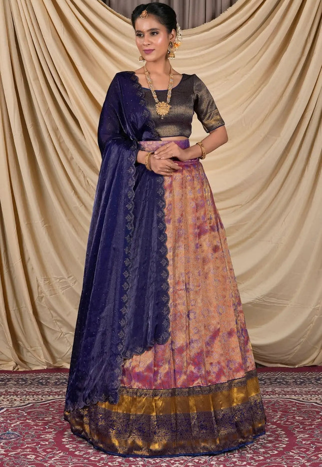 Woman wearing a traditional outfit with a blue dupatta and patterned skirt