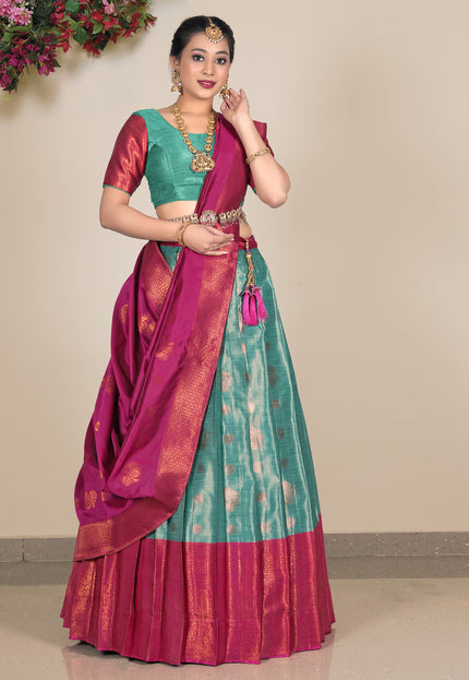 Woman wearing a traditional saree with a green lehenga and blouse and pink dupatta