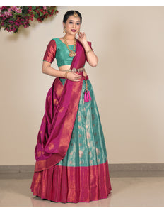 Woman wearing a traditional saree with a green lehenga and blouse and pink dupatta