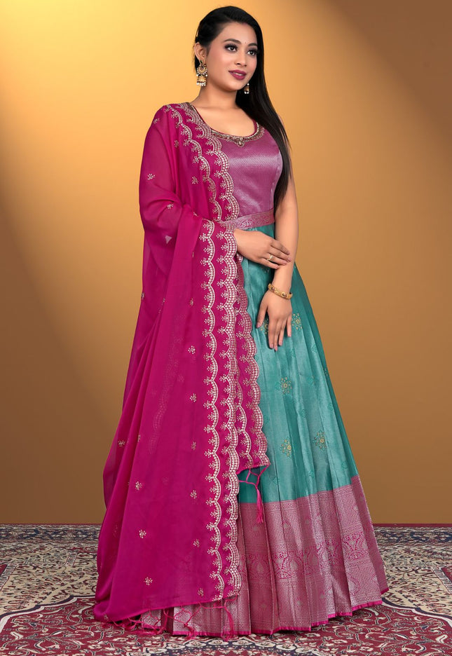 Woman wearing a pink and teal gown with a matching dupatta