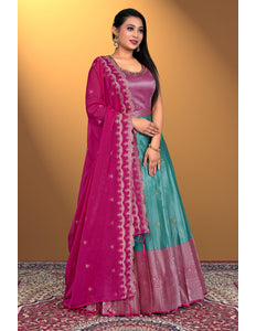 Woman wearing a pink and teal gown with a matching dupatta