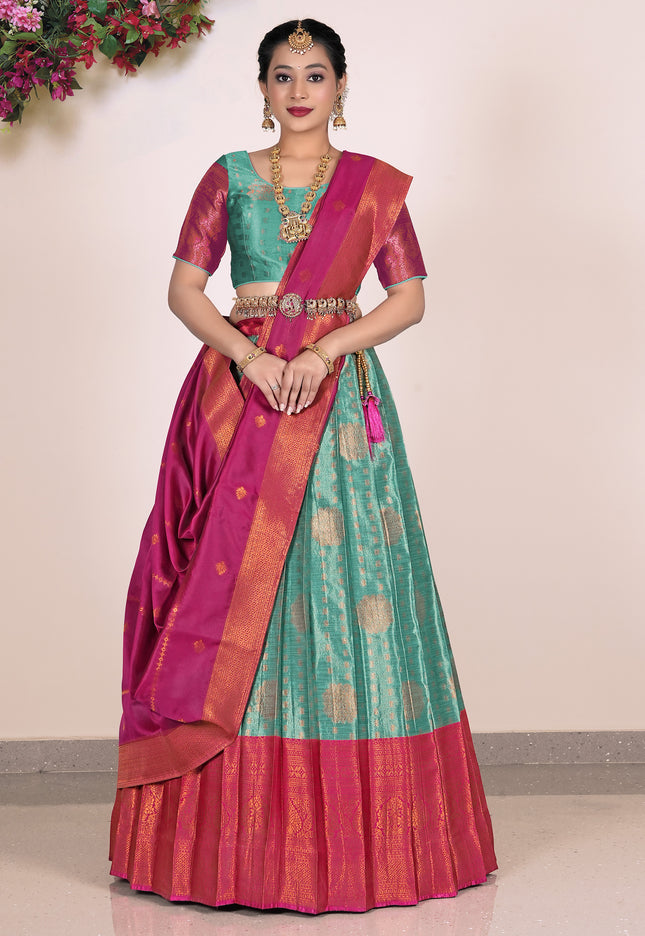 Woman wearing a traditional saree with a Rama and Pink Blouse