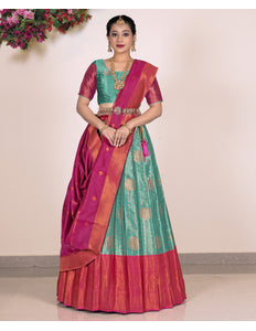 Woman wearing a traditional saree with a Rama and Pink Blouse