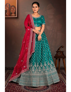 Woman in a teal and red traditional lehenga choli with red dupatta