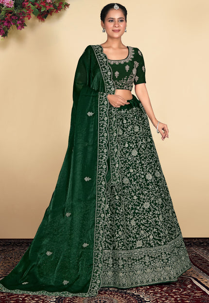 Woman wearing a green embroidered traditional outfit