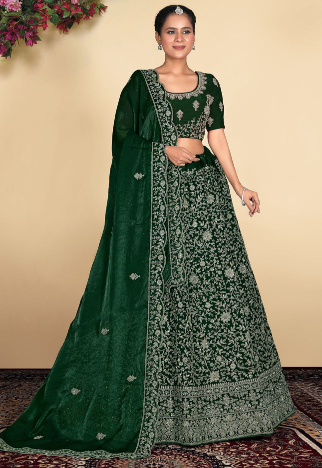 Woman wearing a green embroidered traditional outfit