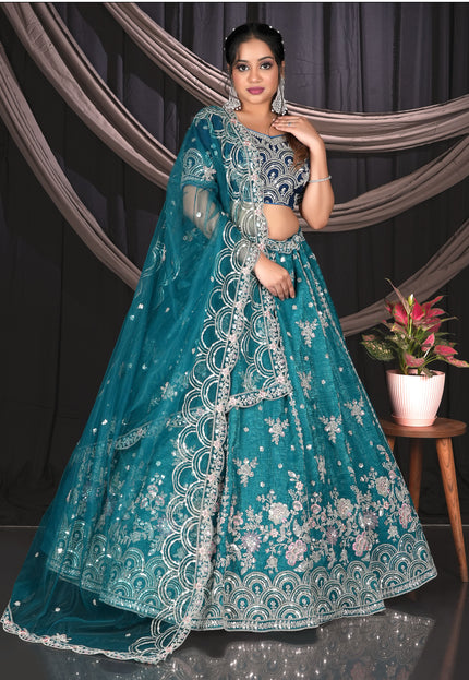 Woman in a teal embroidered traditional outfit