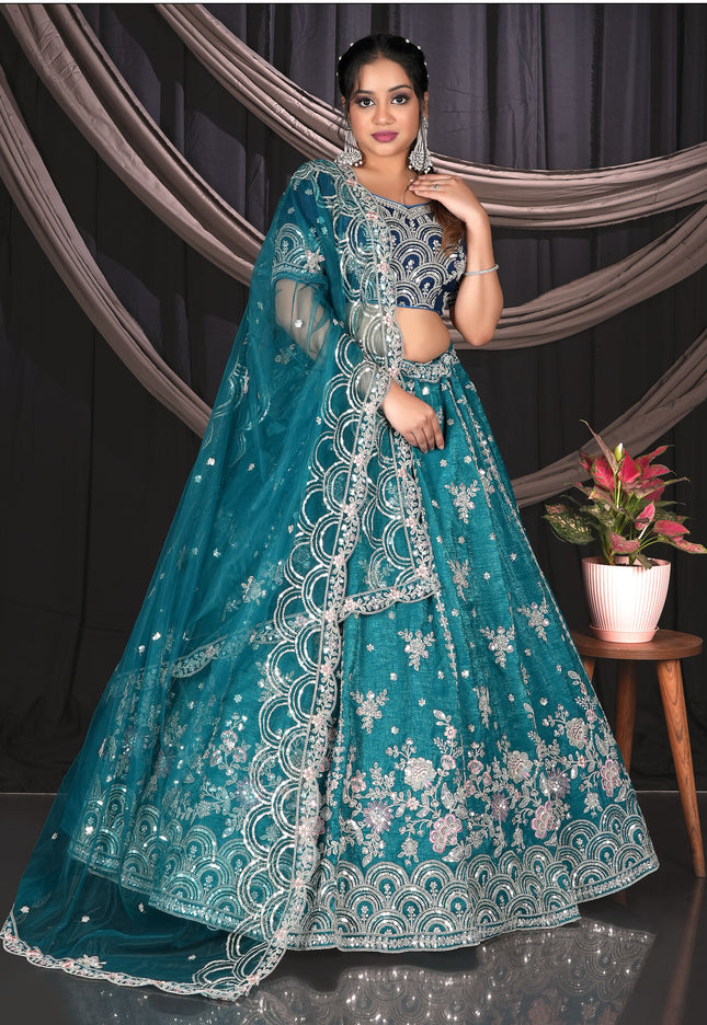 Woman in a teal embroidered traditional outfit