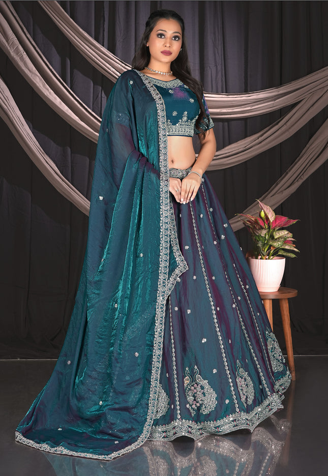Woman in a teal embroidered traditional lehenga choli