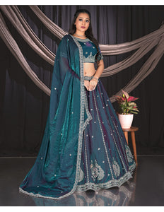 Woman in a teal embroidered traditional lehenga choli